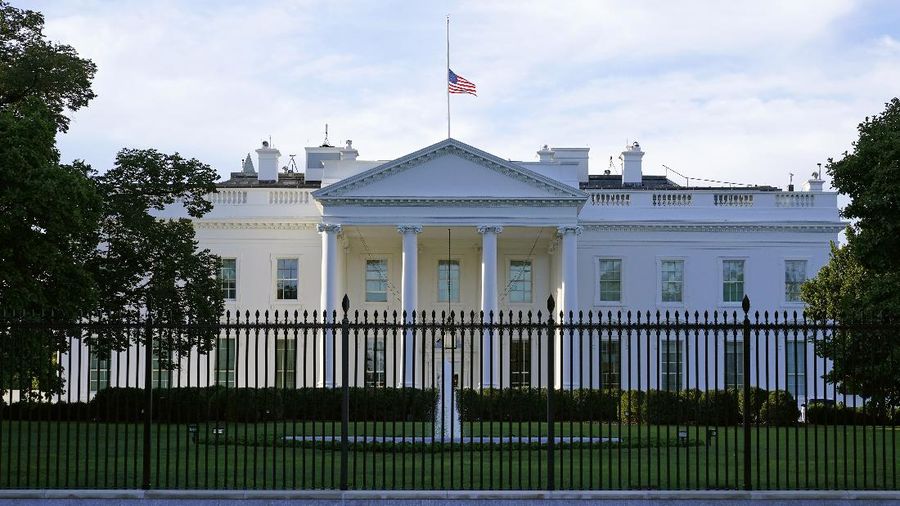 FILE - In this Saturday, Sept. 19, 2020, file photo, an American flag flies at half-staff over the White House in Washington. A woman suspected of sending an envelope containing the poison ricin, which was addressed to White House, has been arrested at the New York-Canada border. (AP Photo/Patrick Semansky, File)