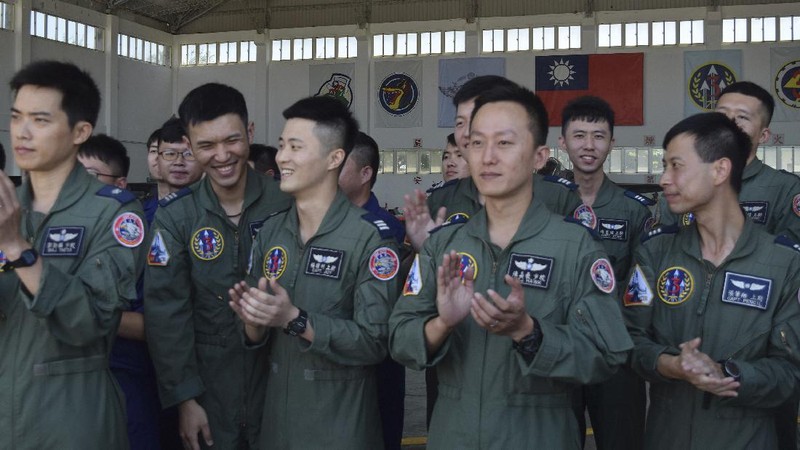 Taiwan President Tsai Ing-wen, center, speaks near Taiwan's Indigenous Defense Fighter (IDF) jets displayed during a visit to the Penghu Magong military air base in outlying Penghu Island, Taiwan Tuesday, Sept. 22, 2020. Tsai visited the military base on one of Taiwan’s outlying islands Tuesday in a display of resolve following a recent show of force by rival China. (AP Photo/Johnson Lai)