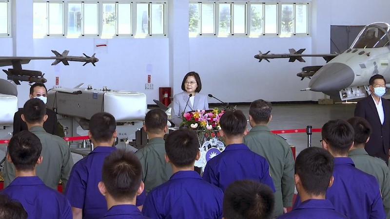 Taiwan President Tsai Ing-wen, center, speaks near Taiwan's Indigenous Defense Fighter (IDF) jets displayed during a visit to the Penghu Magong military air base in outlying Penghu Island, Taiwan Tuesday, Sept. 22, 2020. Tsai visited the military base on one of Taiwan’s outlying islands Tuesday in a display of resolve following a recent show of force by rival China. (AP Photo/Johnson Lai)