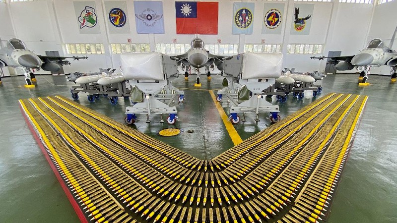 Taiwan President Tsai Ing-wen, center, speaks near Taiwan's Indigenous Defense Fighter (IDF) jets displayed during a visit to the Penghu Magong military air base in outlying Penghu Island, Taiwan Tuesday, Sept. 22, 2020. Tsai visited the military base on one of Taiwan’s outlying islands Tuesday in a display of resolve following a recent show of force by rival China. (AP Photo/Johnson Lai)