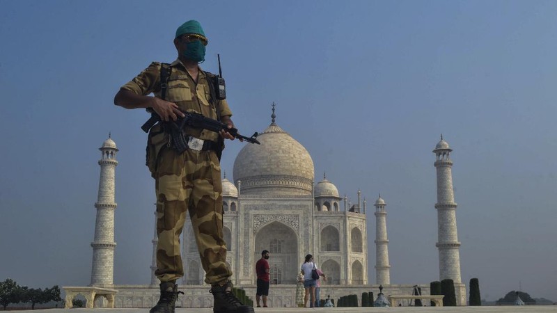 A paramilitary soldier wearing a mask stands guard as the Taj Mahal monument is reopened after being closed for more than six months due to the coronavirus pandemic in Agra, India, Monday, Sept.21, 2020. (AP Photo/Pawan Sharma)