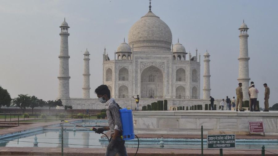A paramilitary soldier wearing a mask stands guard as the Taj Mahal monument is reopened after being closed for more than six months due to the coronavirus pandemic in Agra, India, Monday, Sept.21, 2020. (AP Photo/Pawan Sharma)