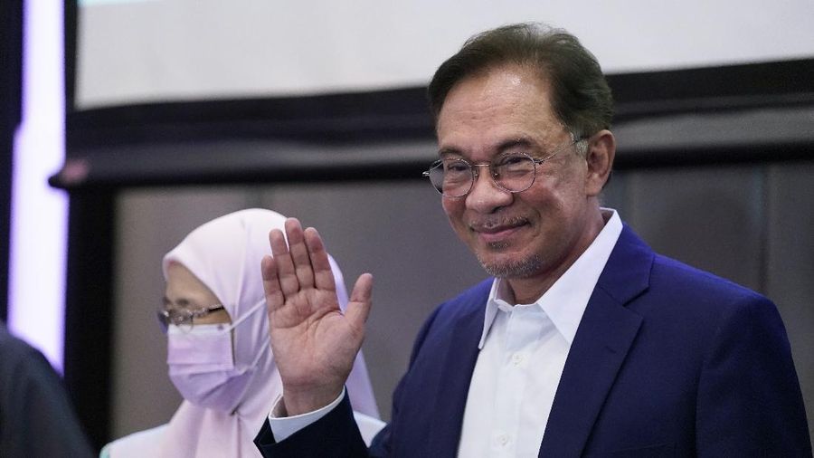 Malaysia's opposition leader Anwar Ibrahim gestures as he leaves after a press conference in Kuala Lumpur, Wednesday, Sept. 23, 2020. Anwar said he has secured a majority in parliament to form a new government that is “strong, stable and formidable.