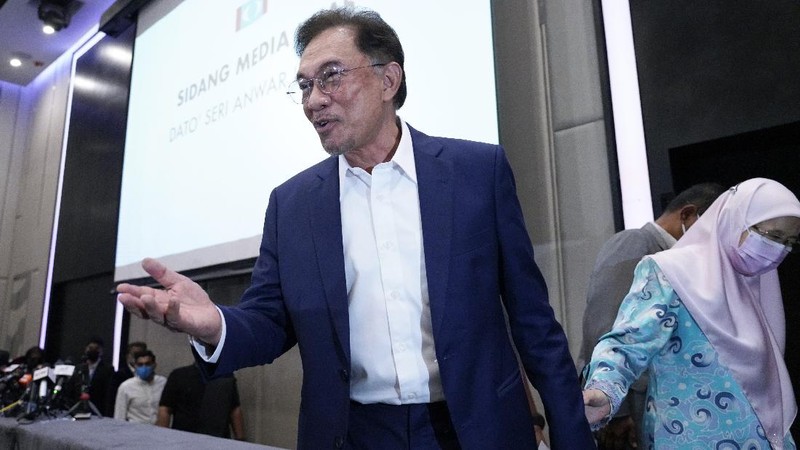 Malaysia's opposition leader Anwar Ibrahim gestures as he leaves after a press conference in Kuala Lumpur, Wednesday, Sept. 23, 2020. Anwar said he has secured a majority in parliament to form a new government that is “strong, stable and formidable.