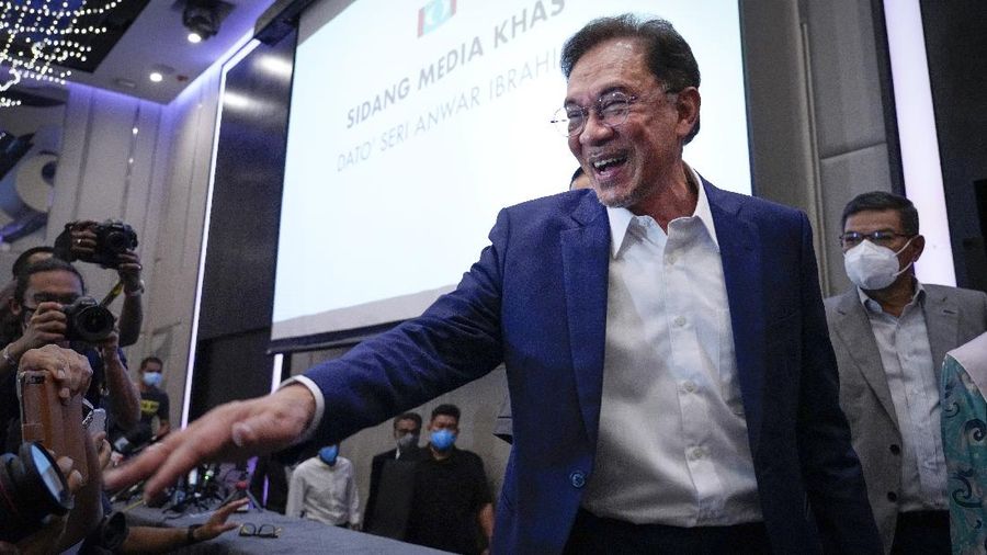 Malaysia's opposition leader Anwar Ibrahim gestures as he leaves after a press conference in Kuala Lumpur, Wednesday, Sept. 23, 2020. Anwar said he has secured a majority in parliament to form a new government that is “strong, stable and formidable.