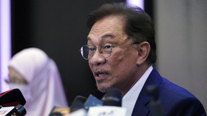 Malaysia's opposition leader Anwar Ibrahim gestures as he leaves after a press conference in Kuala Lumpur, Wednesday, Sept. 23, 2020. Anwar said he has secured a majority in parliament to form a new government that is “strong, stable and formidable.