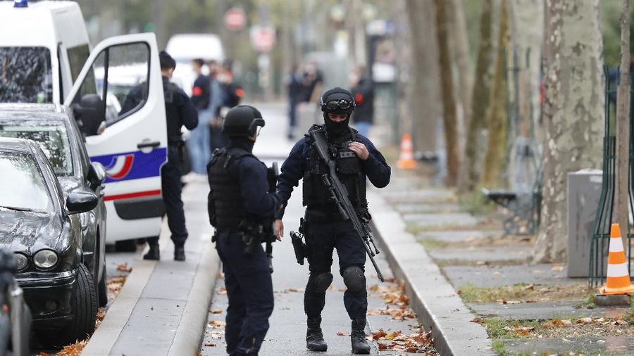Riot police officers arrive after four people have been wounded in a knife attack near the former offices of satirical newspaper Charlie Hebdo, Friday Sept. 25, 2020 in Paris. A police official said officers are 
