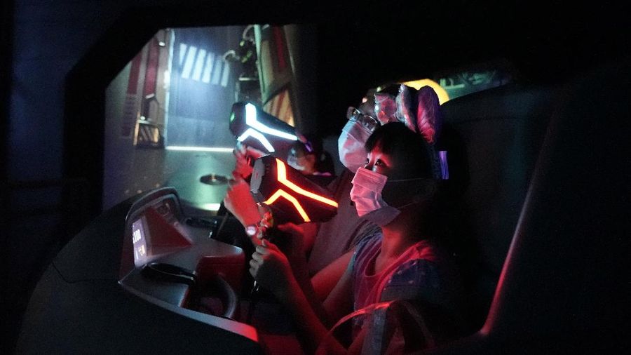 Visitors wearing face masks line up to take photos with the iconic cartoon characters Donald Duck and Daisy Duck at the Hong Kong Disneyland, Friday, Sept. 25, 2020. Hong Kong Disneyland reopened its doors to visitors after closed temporarily due to the coronavirus outbreak. (AP Photo/Kin Cheung)