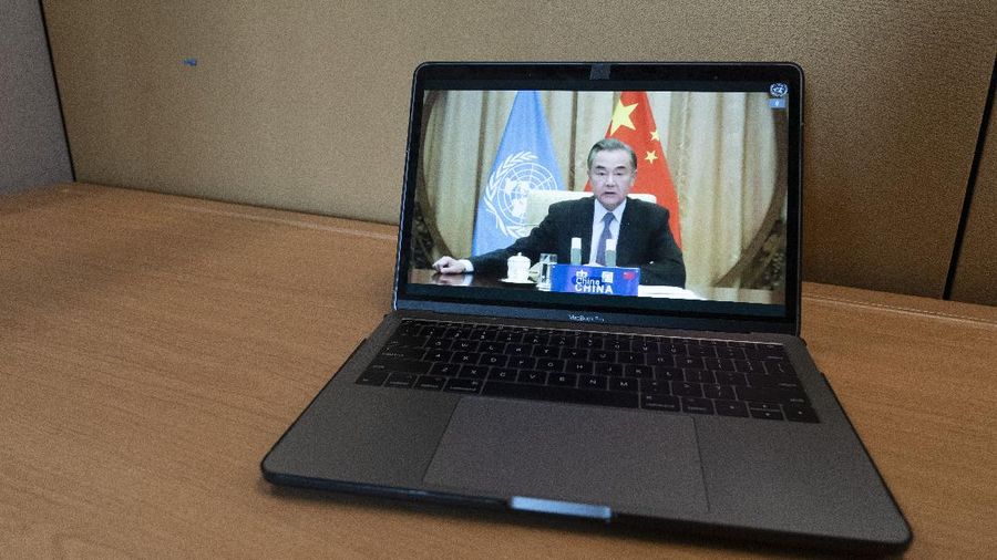 Chinese Foreign Minister Wang Yi is seen on a computer monitor at United Nations headquarters as he speaks during a virtual high-level meeting of the Security Council meeting on safeguarding international peace and security and global governance in the post-COVID-19 era happening during the 75th session of the United Nations General Assembly, Thursday, Sept. 24, 2020. (AP Photo/Mary Altaffer)