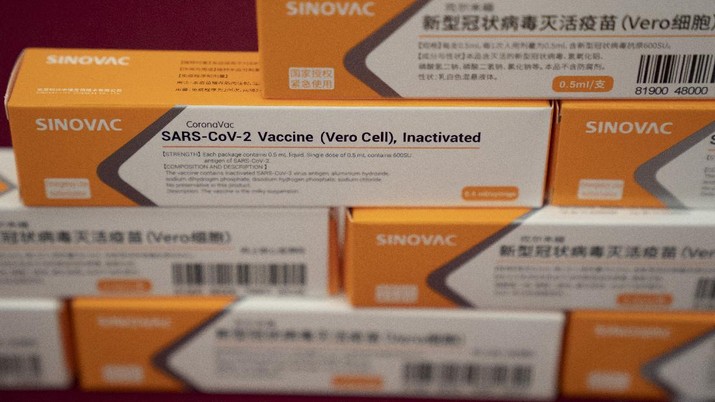 A worker inspects vials of SARS CoV-2 Vaccine for COVID-19 produced by SinoVac at its factory in Beijing on Thursday, Sept. 24, 2020. A Chinese health official said Friday, Sept. 25, 2020, that the country's annual production capacity for coronavirus vaccines will top 1 billion doses next year, following an aggressive government support program for construction of new factories. (AP Photo/Ng Han Guan)