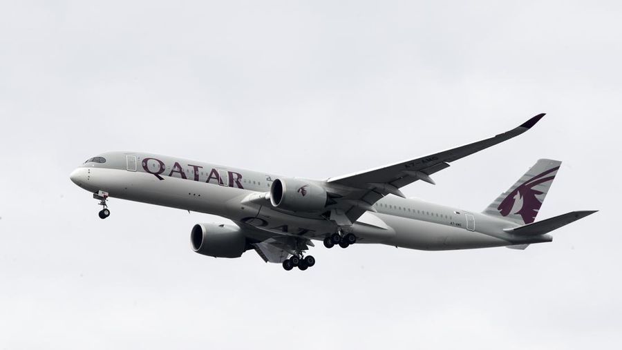 FILE - In this Nov. 7, 2019 file photo, a Qatar Airways jet approaches Philadelphia International Airport in Philadelphia. Long-haul carrier Qatar Airways on Sunday, Sept. 27, 2020, reported revenue losses of $1.9 billion for the past year, blaming the coronavirus pandemic, its liquidation of shares in Air Italy and the ongoing boycott of Doha by four Arab nations for the drop. (AP Photo/Matt Rourke, File)