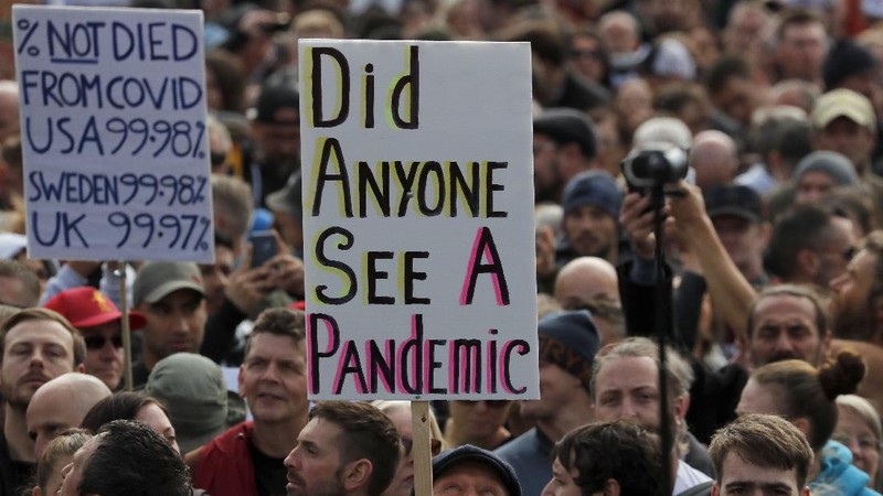People take part in a 'We Do Not Consent' rally at Trafalgar Square, organised by Stop New Normal, to protest against coronavirus restrictions, in London, Saturday, Sept. 26, 2020. (Stefan Rousseau/PA via AP)