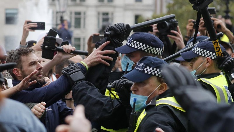 People take part in a 'We Do Not Consent' rally at Trafalgar Square, organised by Stop New Normal, to protest against coronavirus restrictions, in London, Saturday, Sept. 26, 2020. (Stefan Rousseau/PA via AP)