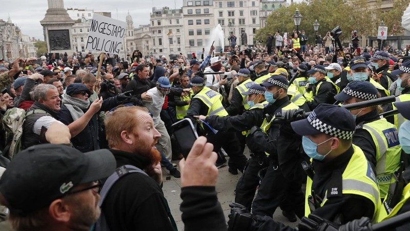 People take part in a 'We Do Not Consent' rally at Trafalgar Square, organised by Stop New Normal, to protest against coronavirus restrictions, in London, Saturday, Sept. 26, 2020. (Stefan Rousseau/PA via AP)