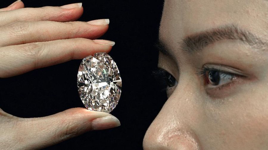 A 102.39 carat, D color, flawless diamond is displayed by a model at a Sotheby’s auction room in Hong Kong Monday, Sept. 28, 2020. It is the first time that a diamond this size and caliber will be actioned without reservations in history. (AP Photo/Vincent Yu)