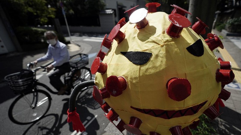 People wearing protective masks to help curb the spread of the coronavirus walk at shopping arcade at Asakusa district Tuesday, Sept. 29, 2020, in Tokyo. The Japanese capital confirmed more than 200 coronavirus cases on Tuesday. (AP Photo/Eugene Hoshiko)