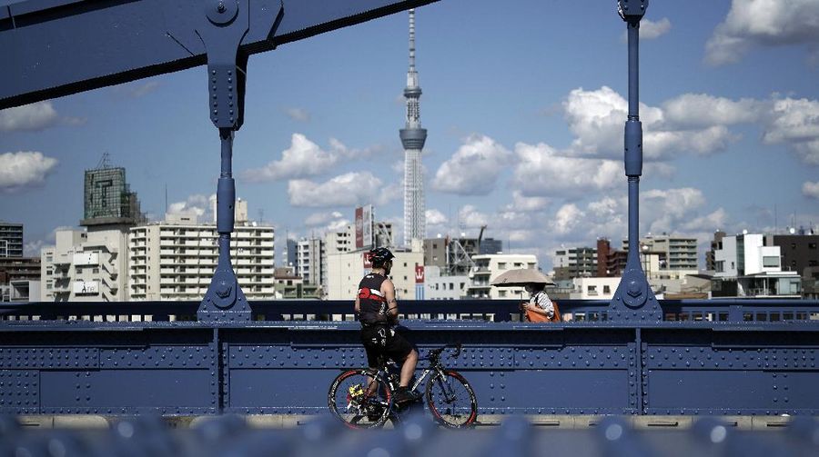 People wearing protective masks to help curb the spread of the coronavirus walk at shopping arcade at Asakusa district Tuesday, Sept. 29, 2020, in Tokyo. The Japanese capital confirmed more than 200 coronavirus cases on Tuesday. (AP Photo/Eugene Hoshiko)