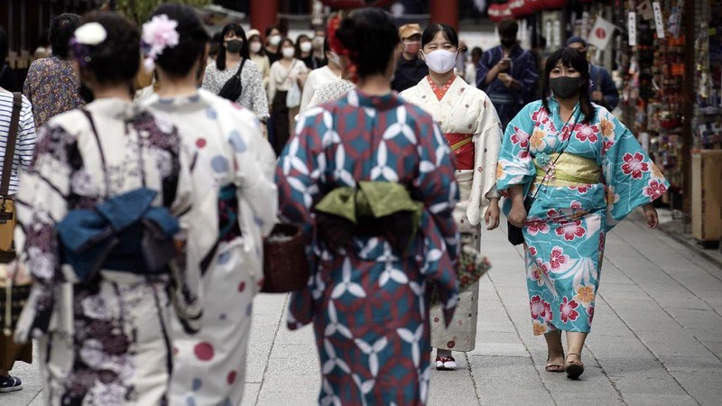 People wearing protective masks to help curb the spread of the coronavirus walk at shopping arcade at Asakusa district Tuesday, Sept. 29, 2020, in Tokyo. The Japanese capital confirmed more than 200 coronavirus cases on Tuesday. (AP Photo/Eugene Hoshiko)