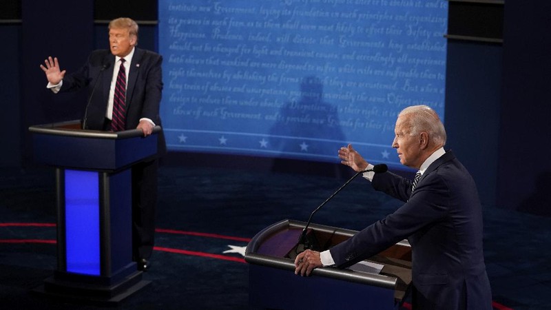 Democratic presidential candidate former Vice President Joe Biden gestures as President Donald Trump walks onto stage for the first presidential debate Tuesday, Sept. 29, 2020, at Case Western University and Cleveland Clinic, in Cleveland. (Olivier Douliery/Pool vi AP)