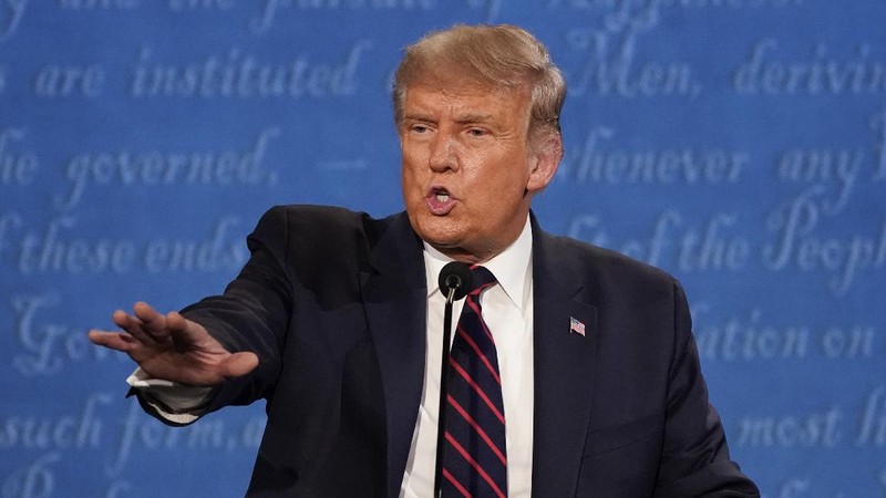 Democratic presidential candidate former Vice President Joe Biden gestures as President Donald Trump walks onto stage for the first presidential debate Tuesday, Sept. 29, 2020, at Case Western University and Cleveland Clinic, in Cleveland. (Olivier Douliery/Pool vi AP)