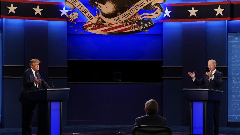 Democratic presidential candidate former Vice President Joe Biden gestures as President Donald Trump walks onto stage for the first presidential debate Tuesday, Sept. 29, 2020, at Case Western University and Cleveland Clinic, in Cleveland. (Olivier Douliery/Pool vi AP)