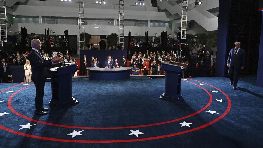 Democratic presidential candidate former Vice President Joe Biden gestures as President Donald Trump walks onto stage for the first presidential debate Tuesday, Sept. 29, 2020, at Case Western University and Cleveland Clinic, in Cleveland. (Olivier Douliery/Pool vi AP)