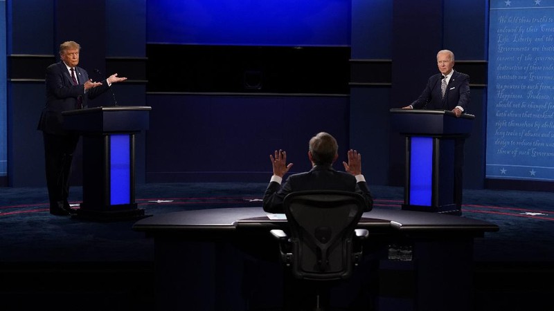 Democratic presidential candidate former Vice President Joe Biden gestures as President Donald Trump walks onto stage for the first presidential debate Tuesday, Sept. 29, 2020, at Case Western University and Cleveland Clinic, in Cleveland. (Olivier Douliery/Pool vi AP)