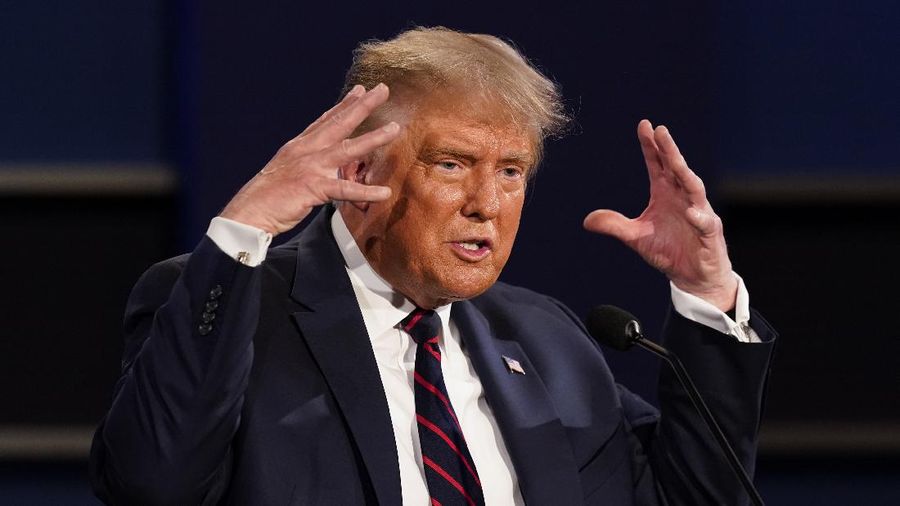 Democratic presidential candidate former Vice President Joe Biden gestures as President Donald Trump walks onto stage for the first presidential debate Tuesday, Sept. 29, 2020, at Case Western University and Cleveland Clinic, in Cleveland. (Olivier Douliery/Pool vi AP)