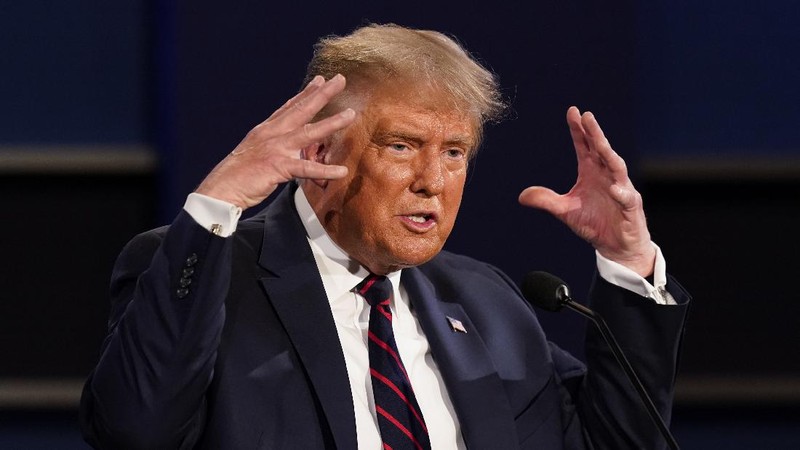 Democratic presidential candidate former Vice President Joe Biden gestures as President Donald Trump walks onto stage for the first presidential debate Tuesday, Sept. 29, 2020, at Case Western University and Cleveland Clinic, in Cleveland. (Olivier Douliery/Pool vi AP)