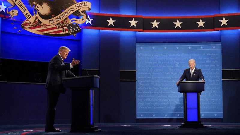 Democratic presidential candidate former Vice President Joe Biden gestures as President Donald Trump walks onto stage for the first presidential debate Tuesday, Sept. 29, 2020, at Case Western University and Cleveland Clinic, in Cleveland. (Olivier Douliery/Pool vi AP)
