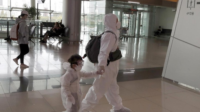 Passengers wearing face masks to help protect against the spread of the coronavirus line up to board planes ahead of the upcoming Chuseok holiday, the Korean version of Thanksgiving Day, at the domestic flight terminal of Gimpo airport in Seoul, South Korea, Wednesday, Sept. 30, 2020. (AP Photo/Ahn Young-joon)