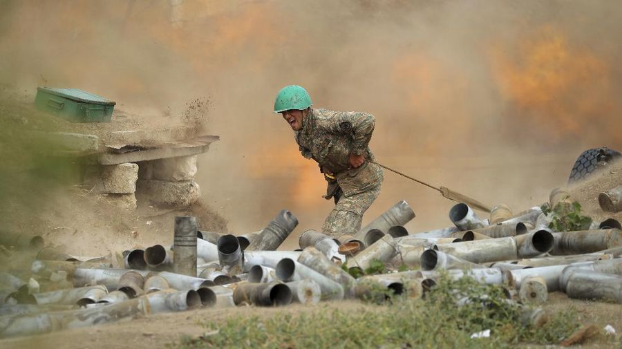 An Armenian serviceman fires a cannon towards Azerbaijan positions in the self-proclaimed Republic of Nagorno-Karabakh, Azerbaijan, Tuesday, Sept. 29, 2020. Armenian and Azerbaijani forces accused each other of attacks on their territory Tuesday, as fighting over the separatist region of Nagorno-Karabakh continued for a third straight day following the reigniting of a decades-old conflict. (Sipan Gyulumyan/Armenian Defense Ministry Press Service/PAN Photo via AP)