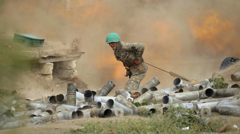 An Armenian serviceman fires a cannon towards Azerbaijan positions in the self-proclaimed Republic of Nagorno-Karabakh, Azerbaijan, Tuesday, Sept. 29, 2020. Armenian and Azerbaijani forces accused each other of attacks on their territory Tuesday, as fighting over the separatist region of Nagorno-Karabakh continued for a third straight day following the reigniting of a decades-old conflict. (Sipan Gyulumyan/Armenian Defense Ministry Press Service/PAN Photo via AP)