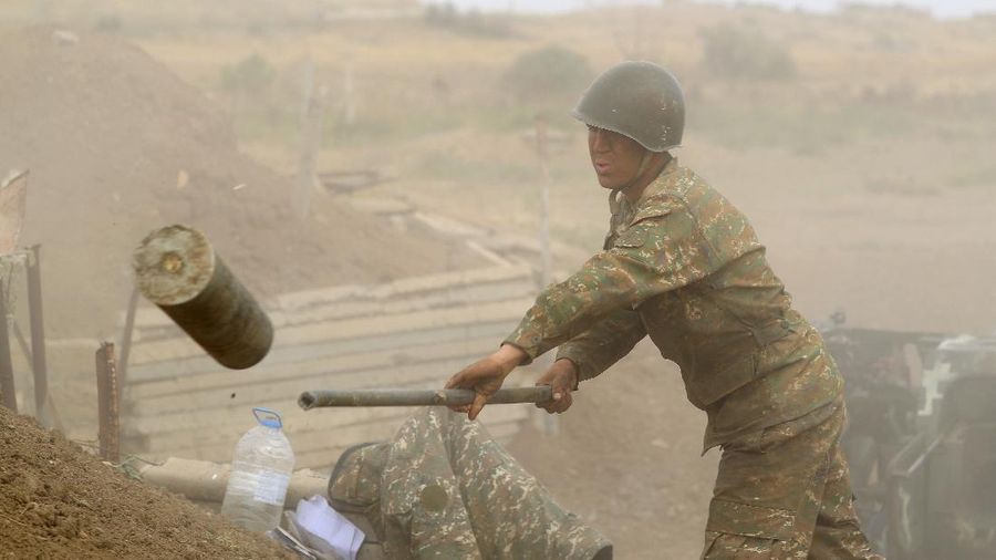 An Armenian serviceman fires a cannon towards Azerbaijan positions in the self-proclaimed Republic of Nagorno-Karabakh, Azerbaijan, Tuesday, Sept. 29, 2020. Armenian and Azerbaijani forces accused each other of attacks on their territory Tuesday, as fighting over the separatist region of Nagorno-Karabakh continued for a third straight day following the reigniting of a decades-old conflict. (Sipan Gyulumyan/Armenian Defense Ministry Press Service/PAN Photo via AP)