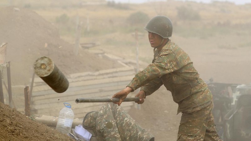 An Armenian serviceman fires a cannon towards Azerbaijan positions in the self-proclaimed Republic of Nagorno-Karabakh, Azerbaijan, Tuesday, Sept. 29, 2020. Armenian and Azerbaijani forces accused each other of attacks on their territory Tuesday, as fighting over the separatist region of Nagorno-Karabakh continued for a third straight day following the reigniting of a decades-old conflict. (Sipan Gyulumyan/Armenian Defense Ministry Press Service/PAN Photo via AP)