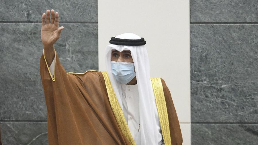 The new Emir of Kuwait Sheikh Nawaf Al Ahmad Al Sabah, waves after he performed the constitutional oath at the Kuwaiti National Assembly in Kuwait, Wednesday, Sept. 30, 2020. Kuwait's Sheikh Nawaf Al Ahmad Al Sabah was sworn in Wednesday as the ruling emir of the tiny oil-rich country, propelled to power by the death of his half-brother after a long career in the security services. (AP Photo/Jaber Abdulkhaleg)