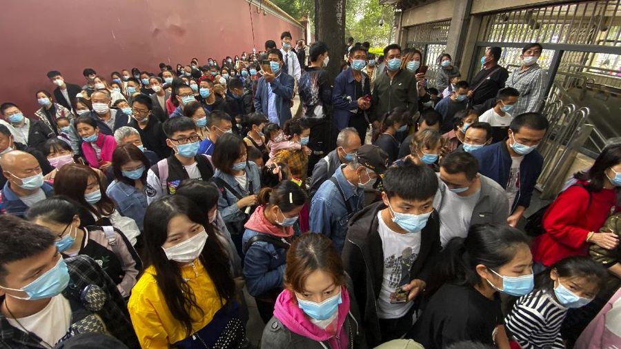 Tourists gather at a waterfront pavilion at the West Lake in Hangzhou in eastern China's Zhejiang Province, Thursday, Oct. 1, 2020. Millions of Chinese tourists usually would use their week-long National Day holidays to travel abroad. This year, travel restrictions due to the coronavirus pandemic mean that some 600 million tourists - about 40% of the population - will travel within China during the holiday that began Thursday, according to Ctrip, China's largest online travel agency. (Chinatopix via AP)