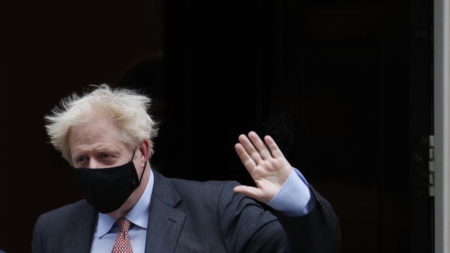 Britain's Prime Minister Boris Johnson waves to the media as he leaves 10 Downing Street or go to the House of Commons his weekly Prime Minister's Questions in London, Wednesday, Sept. 30, 2020. (AP Photo/Alastair Grant)