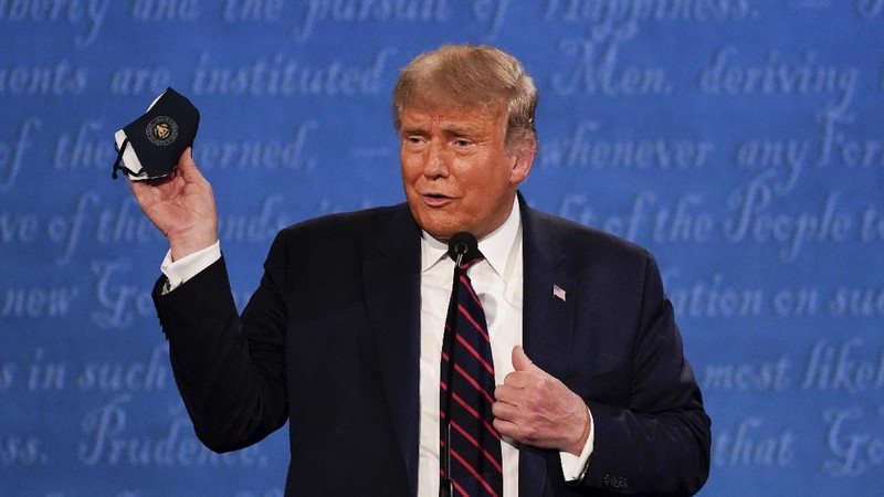 President Donald Trump stands on stage with first lady Melania Trump after the first presidential debate with Democratic presidential candidate former Vice President Joe Biden Tuesday, Sept. 29, 2020, at Case Western University and Cleveland Clinic, in Cleveland, Ohio. President Trump and first lady Melania Trump have tested positive for the coronavirus, the president tweeted early Friday. (AP Photo/Julio Cortez)