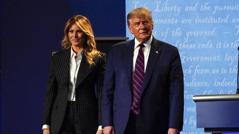 President Donald Trump stands on stage with first lady Melania Trump after the first presidential debate with Democratic presidential candidate former Vice President Joe Biden Tuesday, Sept. 29, 2020, at Case Western University and Cleveland Clinic, in Cleveland, Ohio. President Trump and first lady Melania Trump have tested positive for the coronavirus, the president tweeted early Friday. (AP Photo/Julio Cortez)