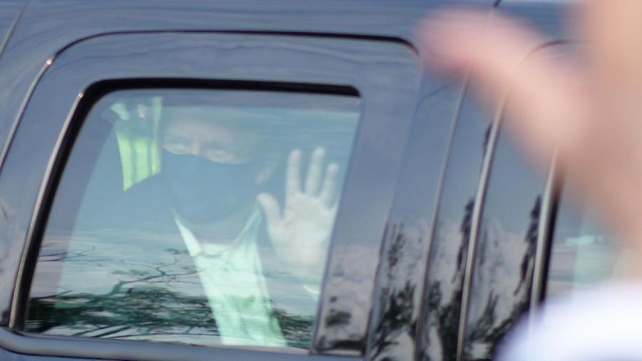 Presiden AS Donald Trump saat melambaikan tangan dari dalam mobil. (AP/Anthony Peltier)
