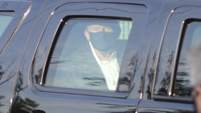 Presiden AS Donald Trump saat melambaikan tangan dari dalam mobil. (AP/Anthony Peltier)