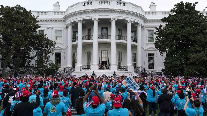 With two bandages on his hand, President Donald Trump gestures while speaking from the Blue Room Balcony of the White House to a crowd of supporters, Saturday, Oct. 10, 2020, in Washington. (AP Photo/Alex Brandon)