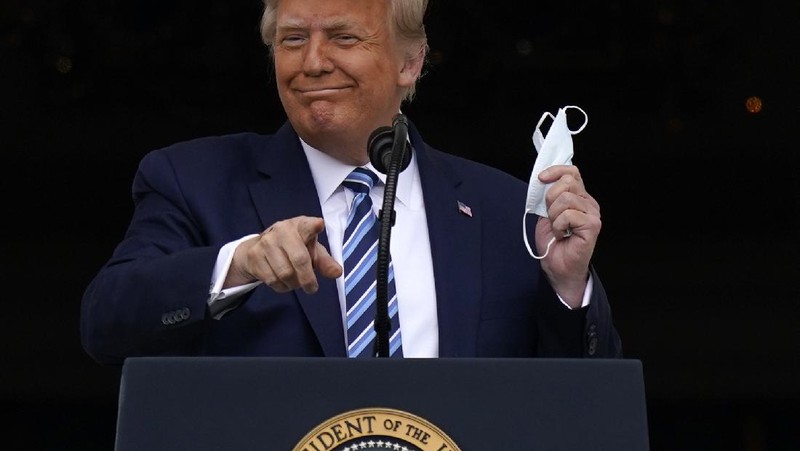 With two bandages on his hand, President Donald Trump gestures while speaking from the Blue Room Balcony of the White House to a crowd of supporters, Saturday, Oct. 10, 2020, in Washington. (AP Photo/Alex Brandon)