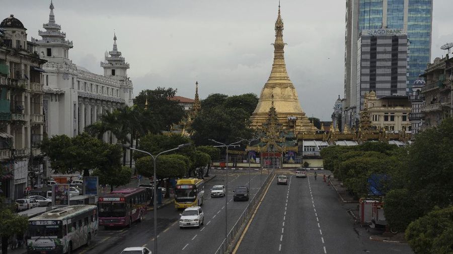 Light traffic can be seen along Sule Pagoda Road in Yangon, Myanmar,Monday, Sept. 21, 2020. Myanmar, faced with a rapidly rising number of coronavirus cases and deaths, has imposed the tightest restrictions so far to fight the spread of the disease in Yangon, the country's biggest city and main transportation hub. (AP Photo/Pyae Sone Win)