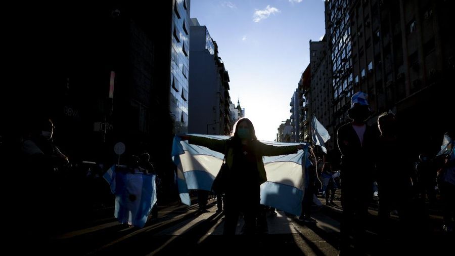 Anti-government demonstrators protest outside the residence of President Alberto Fernandez in Buenos Aires, Argentina, Monday, Oct. 12, 2020. (AP Photo/Natacha Pisarenko)