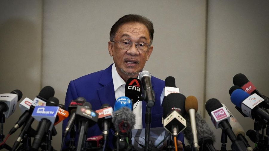 Malaysian opposition leader Anwar Ibrahim speaks during a press conference after meeting the nation's king in Kuala Lumpur, Malaysia, Tuesday, Oct. 13, 2020. Anwar met the king Tuesday in a bid to form a new government after claiming he had secured a majority in Parliament. (AP Photo/Vincent Thian)