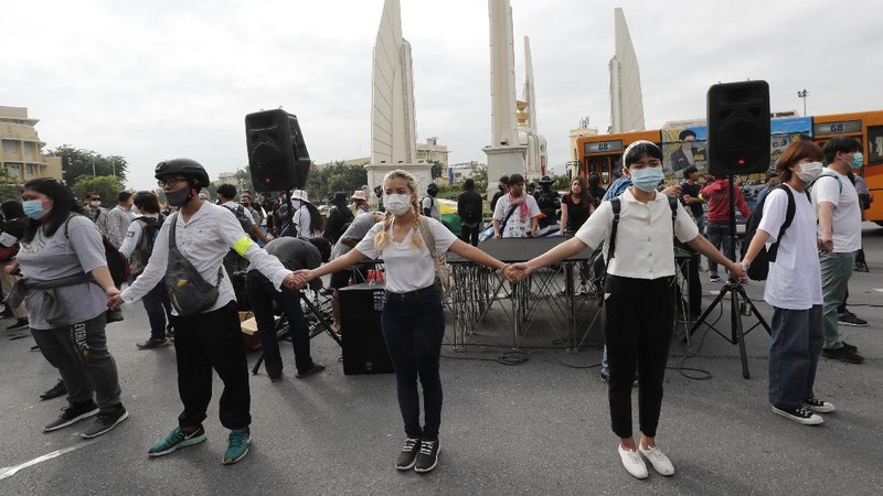 Human rights lawyer Arnon Nampha talks to supporters during a protest near Democracy Monument in Bangkok, Thailand, Wednesday, Oct. 14, 2020. Thai political activists hope to keep up the momentum for their campaign for democratic change with their third major rally in the capital Bangkok on Wednesday. (AP Photo/Sakchai Lalit)