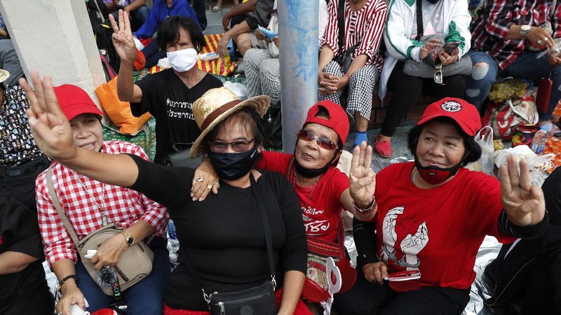 Human rights lawyer Arnon Nampha talks to supporters during a protest near Democracy Monument in Bangkok, Thailand, Wednesday, Oct. 14, 2020. Thai political activists hope to keep up the momentum for their campaign for democratic change with their third major rally in the capital Bangkok on Wednesday. (AP Photo/Sakchai Lalit)
