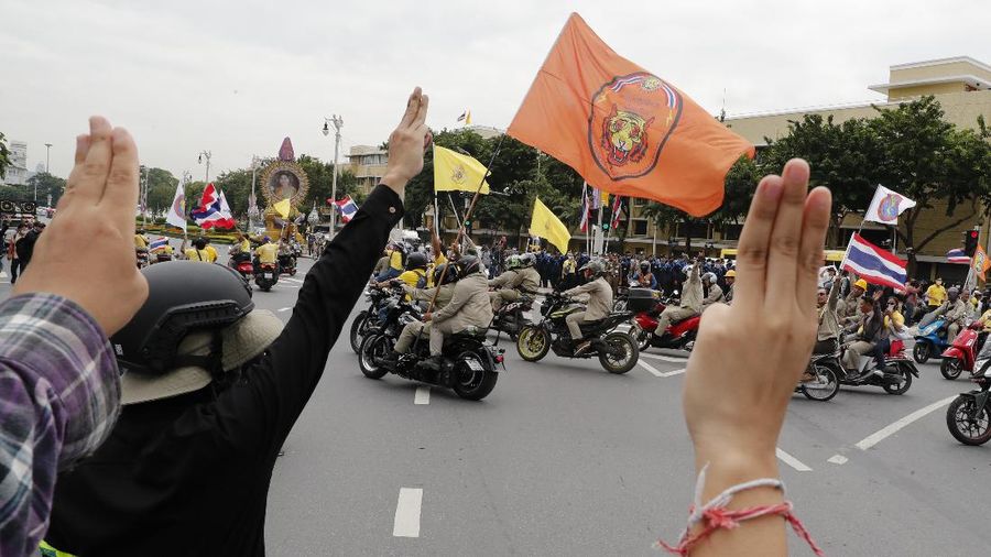 Human rights lawyer Arnon Nampha talks to supporters during a protest near Democracy Monument in Bangkok, Thailand, Wednesday, Oct. 14, 2020. Thai political activists hope to keep up the momentum for their campaign for democratic change with their third major rally in the capital Bangkok on Wednesday. (AP Photo/Sakchai Lalit)